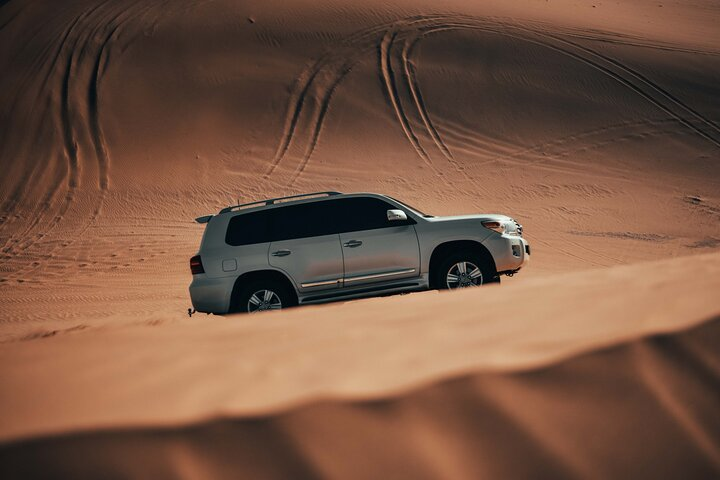 Experience the endless golden dunes of Dubai where luxury meets adventure. Navigate through stunning landscapes perfect for sandboarding and camel riding before indulging in a delightful evening under the stars.